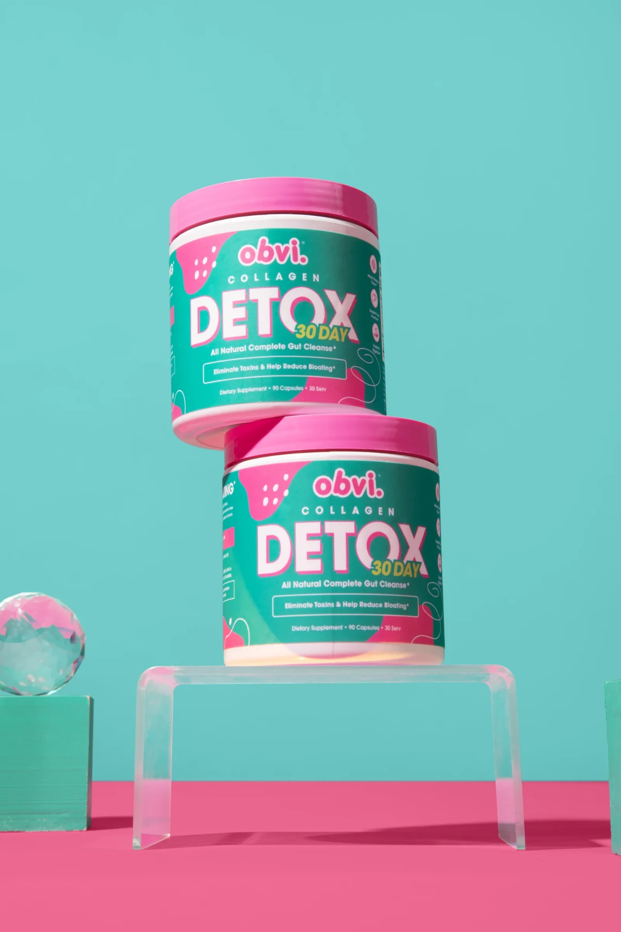 Obvi Collagen Detox bottles in the brand's pink and teal studio setting.