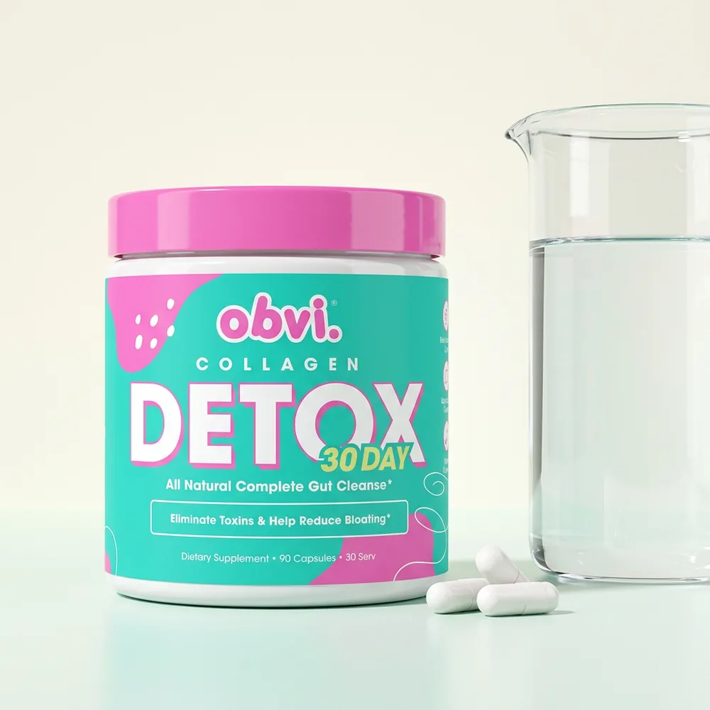 Obvi Collagen Detox jar beside three capsules and a glass of water.