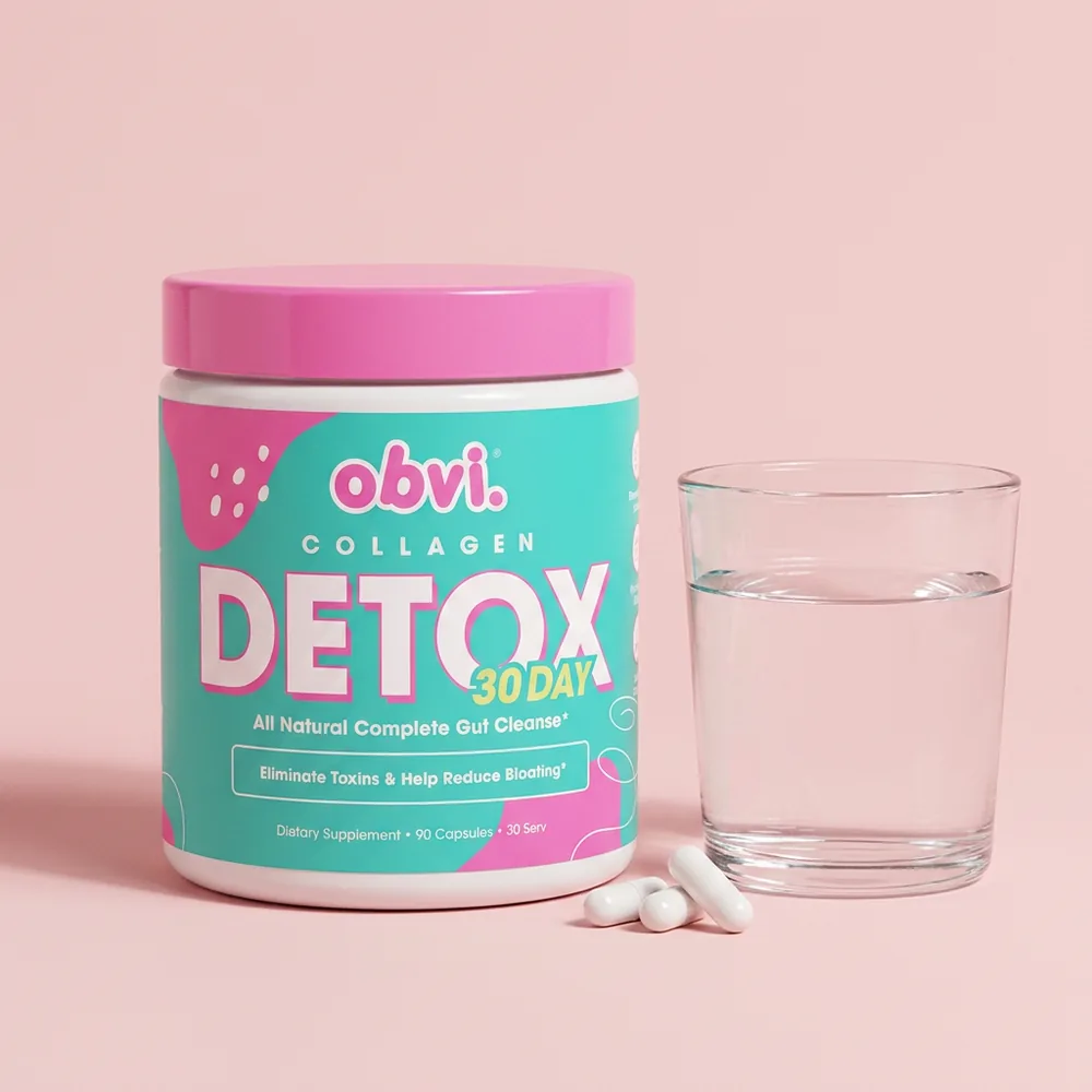 Obvi Collagen Detox jar with three capsules and a glass of water on a soft blush background.
